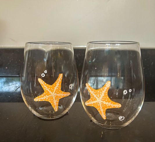 Hand-painted stemless wine glass with orange starfish