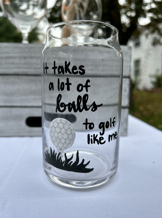 Hand-painted beer glass with golf ball painting with "It takes a lot of balls to golf like me" written in calligraphy.